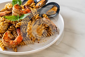 stir-fried spiral pasta with seafood and basil sauce