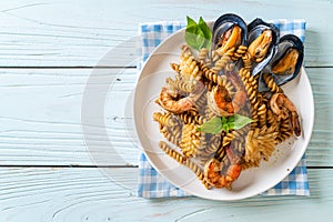 stir-fried spiral pasta with seafood and basil sauce