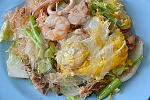 Stir fried sukiyaki with egg and seafood on plate