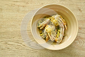 stir fried swimmer crab in yellow curry and egg on bowl