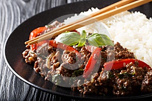 Stir-fried Thai Pad Gra Prow with rice side dish close-up on a plate. horizontal photo