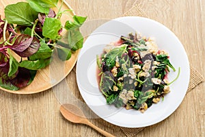 Stir fried Thai spinach with egg on white dish