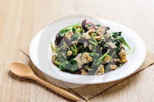 Stir fried Thai spinach with egg on white dish
