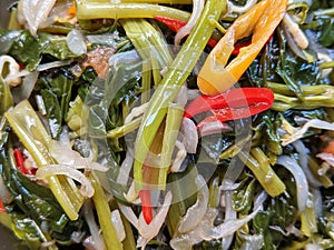 Stir fried water spinach or cah kangkung, asian vegetable dish, extreme close up view
