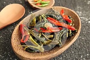 Stir fried water spinach or cah kangkung. Traditional asian indonesian food, cooked veggies, spicy vegetable dish for vegan,