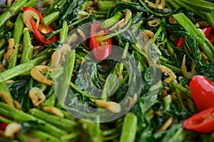 Stir fried Water Spinach or Kangkung with fried Anchovies and Quail eggs. One of the famous Indonesian cuisine. photo