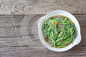 Stir Fried Water Spinach or pak boong fai daeng on white dish