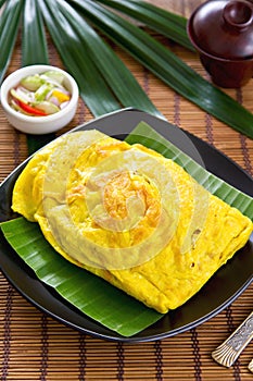 Stir fried wrapped in omelet[Thai's food]