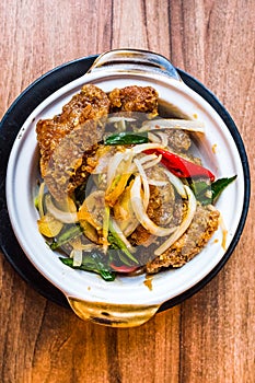 Stir fry crispy golden fried chicken with chilli, onions and spring onions