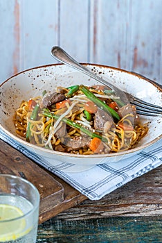 Stir fry duck fillets with noodles