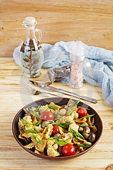 Stir fry farfalle pasta with vegetables, cauliflower and mushrooms