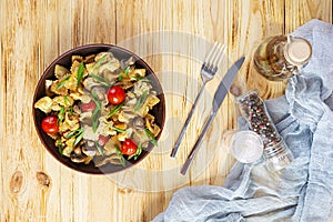 Stir fry farfalle pasta with vegetables, cauliflower and mushrooms. Top view