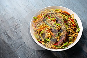 Stir fry noodles with beef and vegetable in white bowl. asian style food
