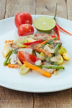 Stir fry vegetables in white dish on wood