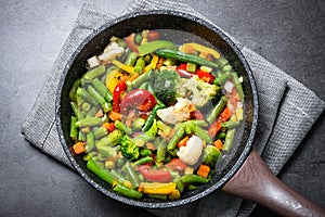 Stir fry vegetables in the wok.