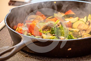 Stir fry veggies in a cast iron pan