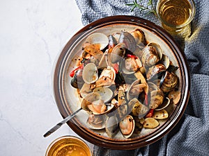 Stir-frying Ginger and clams at high heat to bring forth the savory aroma with sesame oil in recipe