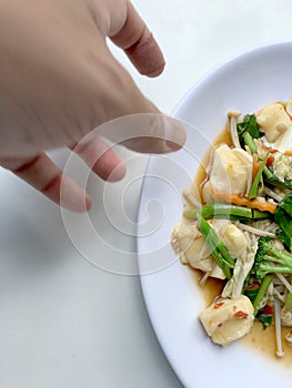 Stir vegetables with Tofu in chinese style with gravy Sauce and thai style omelet with rice in white plate on background. Vegetari