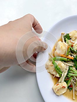 Stir vegetables with Tofu in chinese style with gravy Sauce and thai style omelet with rice in white plate on background. Vegetari