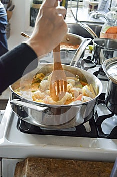 Stirring Brazilian moqueca fish stew