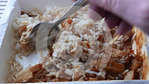 Stirring a chicken with rice TV dinner