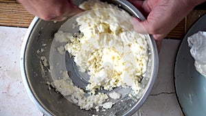 Stirring cottage cheese and egg in a metal bowl