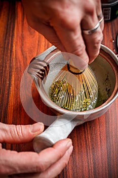 Stirring matcha tea