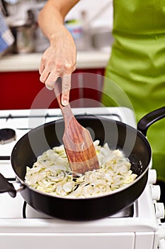 Stirring onion in the pan