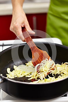 Stirring onion in the pan