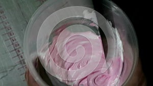 Stirring pink paint to make a shirt process