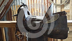 A stirrup on a saddle showing the raw hide and lacing in black and white.