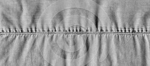 Stitched light black denim cotton jeans fabric texture background