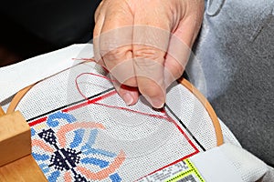 Stitching a needlepoint