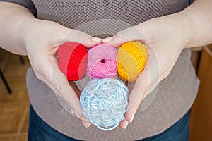 Stitching, yarn, ingrain, thread in female hands in heart shaped. materials for handmade and handiwork - sewing