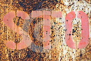 A sto sign on a rusty metal fence, conceptual image for danger