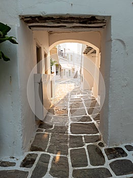 Stoa with shelter and arch over at Naousa village, Paros island, Greece. Vertical