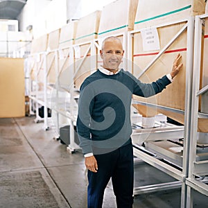 We stock beans from all over the world. Portrait of a mature man standing on the floor of a warehouse.