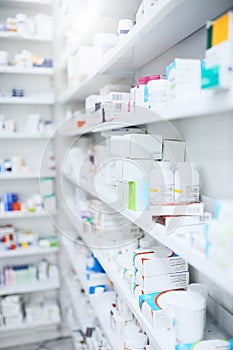 We stock the best. shelves stocked with various medicinal products in a pharmacy.