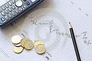 Stock chart with a pencil, a telephone and coins