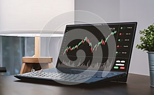 Stock exchange market concept, laptop show graphs analysis candle line screen on the table