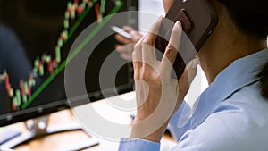 Stock exchange trader working  with graphs,diagrams on monitor in modern trading office