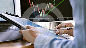 Stock exchange trader working  with graphs,diagrams on monitor in modern trading office