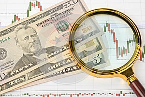 Stock financing, money, economic charts and a magnifying glass. Background for business ideas and design