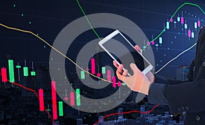 Stock graph with businessman concept, business man or stock trader holding tablet with stock graph chart, stock market analysis co