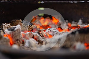 Stock image of charcoal fire grill, close up with live flames.