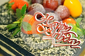Stock image of Happy Birthday candles on chocolate cake