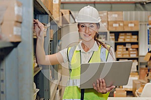 Stock inventory staff women worker with computer software online management realtime warehouse control portrait at work photo