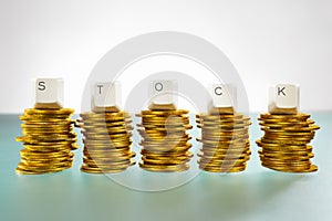 STOCK letter on gold coins stack