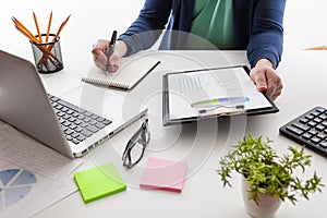 Stock market chart and finger pointing on tablet in office