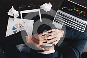 Stock market concept, business man looking at stock market graph on computer screen is showing disappointment after